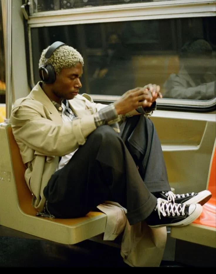 Man listening to music with headphones on a subway train