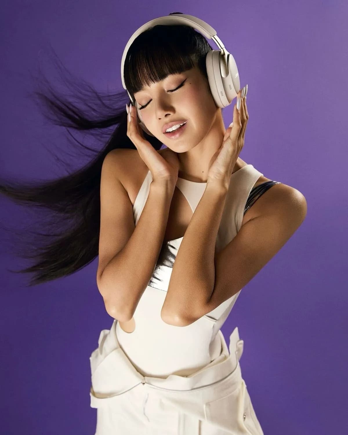 Woman with white headphones on a purple background